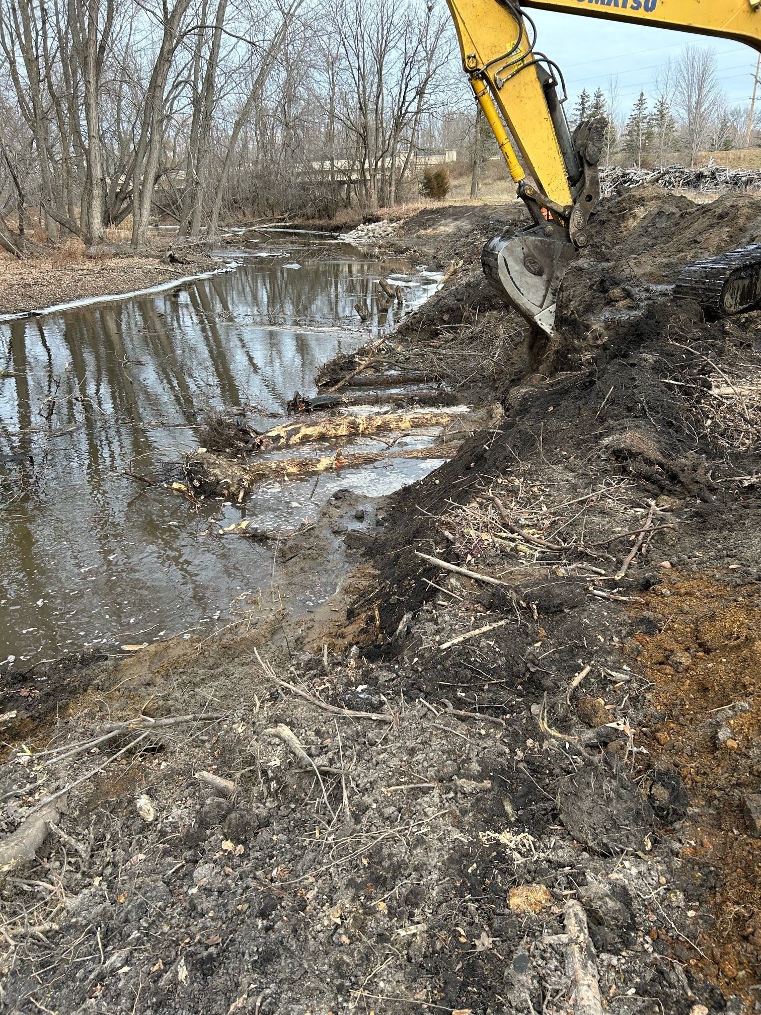 A close shot of the work being completed on the stream by the excavator